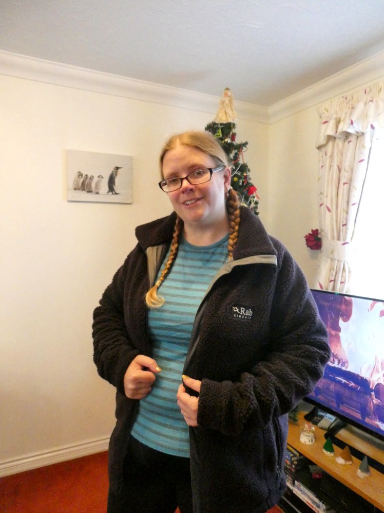 Me in my blue stripy thermal top but now wearing a deep greyish-purple fleece jacket over it. It's the thick fleece of a teddy bear coat and it doesn't quite do up on me anymore.