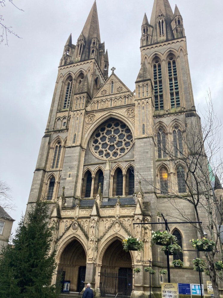 Truro Cathedral west front, a (brick) Gothic cathedral with two towers and a rose window in between.