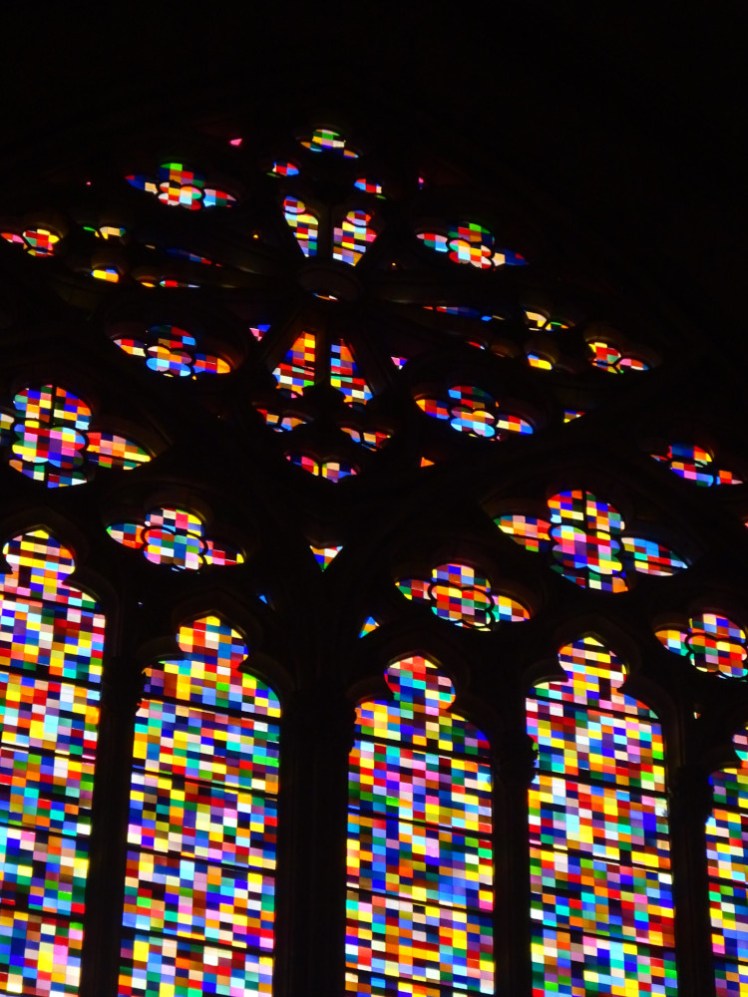 The window that cast the colours in the previous picture. It's a proper Gothic window with a rose at the top but the glass is a random pattern of colour squares, a pixellated window.