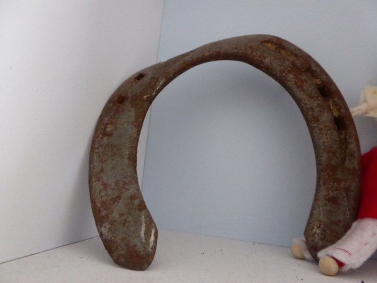 Bent rusty horseshoe on display