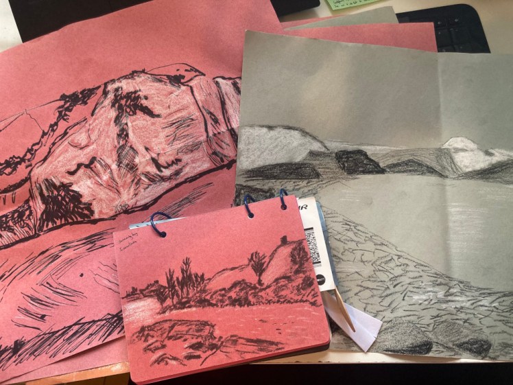 A little pile of charcoal & chalk sketches on coloured sugar paper.