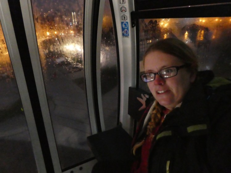 A selfie on the big wheel in Gdansk. I'm in a cabin, it's dark outside and you can see the city lights through the rain-streaked windows.