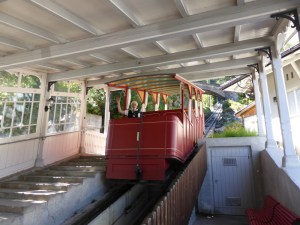 The heritage funicular to the Reichenbach Falls. It's red and open-sided with four tiers of seating under a roof, presumably to keep the spray from the waterfall off you.