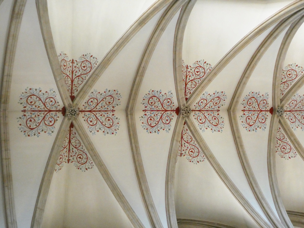 Patterns of red and blue swirls and dots on the ceiling of the cathedral.