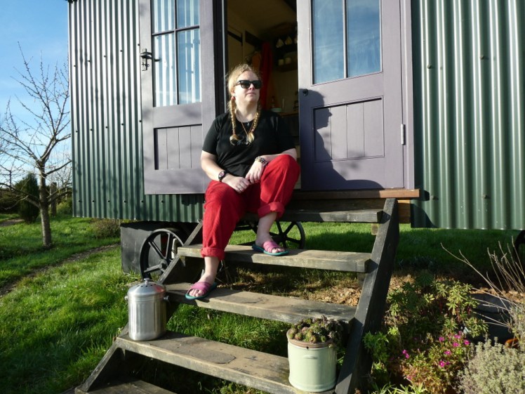 Sitting on the steps of my shepherd's hut in the sun