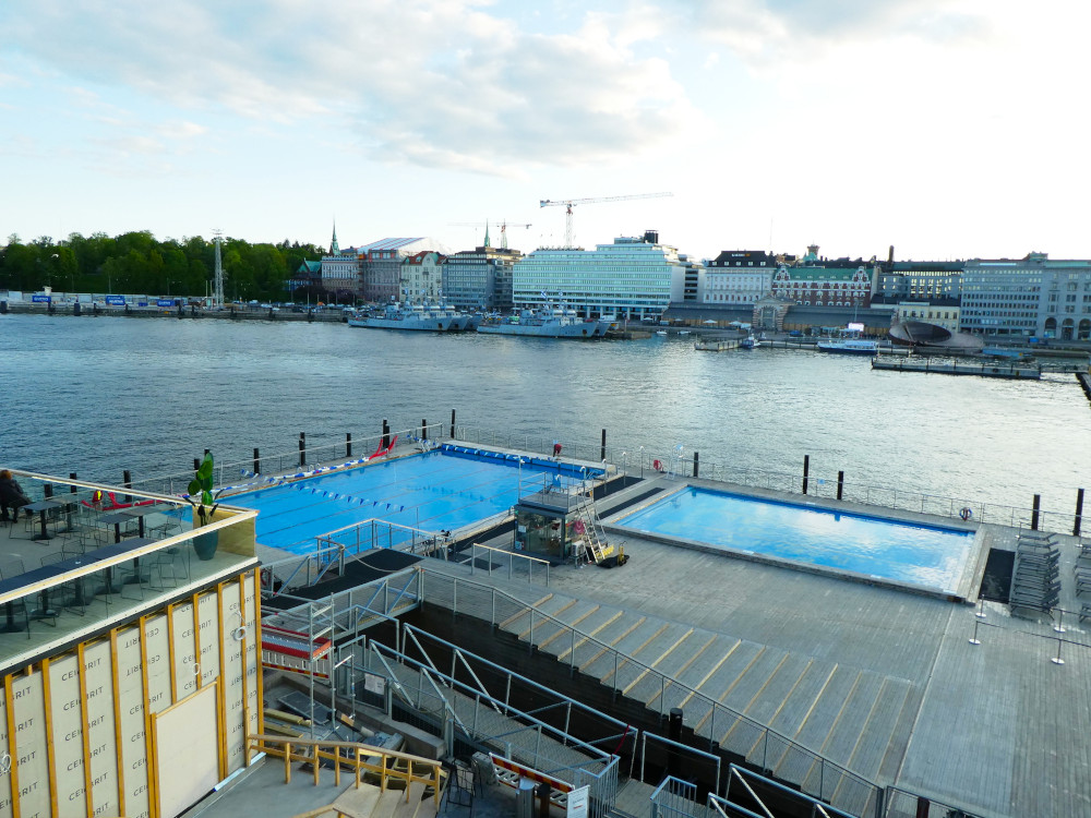 The geothermal pool and kids' pool, which are both very bright blue. It's a bright sunny evening but the pools look very cold.