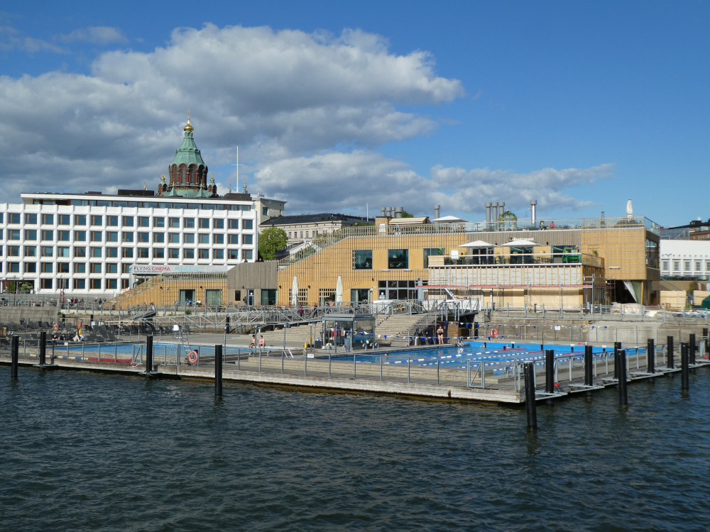 Allas Sea Pool as seen from a boat in the harbour. Now you can see the side of the viewing platform properly, as well as Upenski Cathedral peeking over an office block.