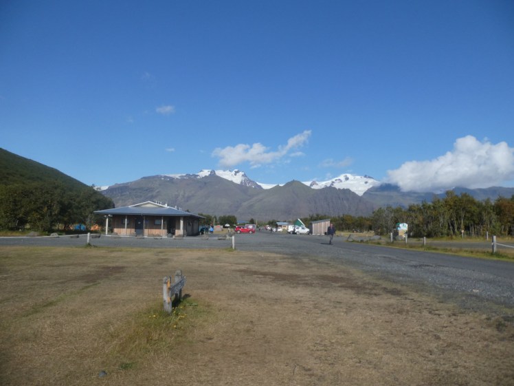 The view across the campsite to the service building and the vast glacier behind that.