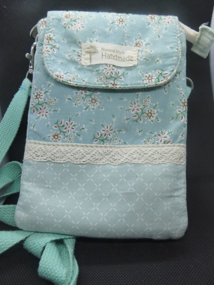 The original bag: a small rectangular bag in green floral fabric with a panel of dotted squares at the bottom.