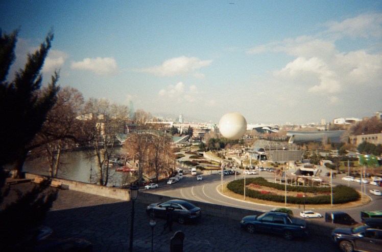 Europe Square from Metekhi Church, with the river on the left, the balloon in the centre and the modern architecture stretching out behind.