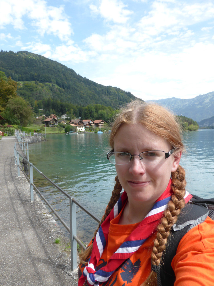A selfie by the lake while I wait for the boat. I'm wearing my orange Our Chalet t-shirt with my red, white & blue striped international neckerchief and my hair is in its usual two plaits.