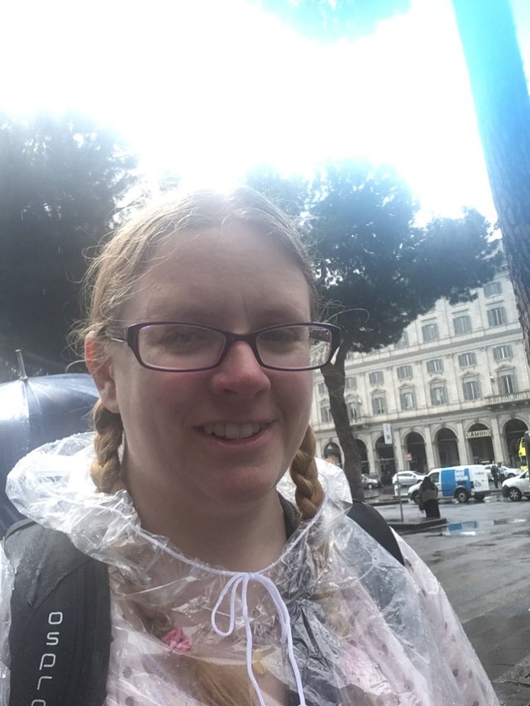 Me, looking very much like a tourist in Rome. I'm soaked because it's just been raining and I'm wearing one of those disposable folding plastic bag coat-things, wearing my big backpack.