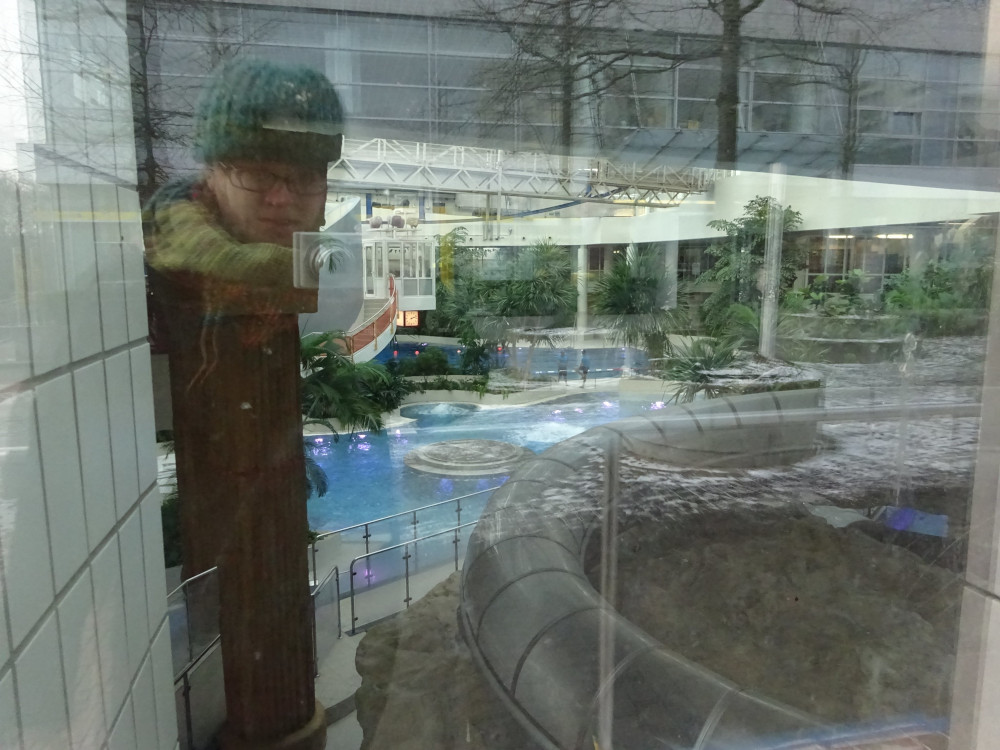 A bad photo of the pools from the outside, mostly featuring my reflection in the window.