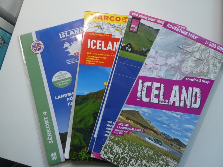 My Iceland road and hiking map collection. Four folded paper maps