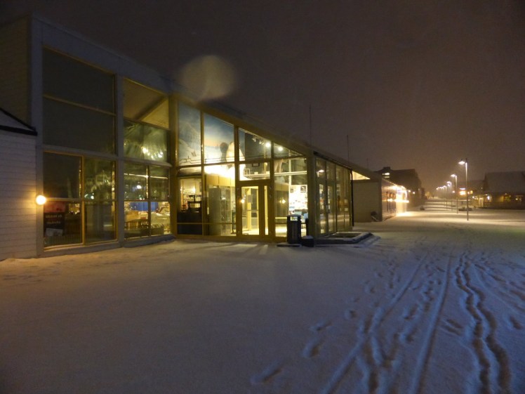 The entrance to Svalbardbutikken. It's a kind of glass conservatory attached to the front of a more warehouse-like building. This is the supermarket in Svalbard.
