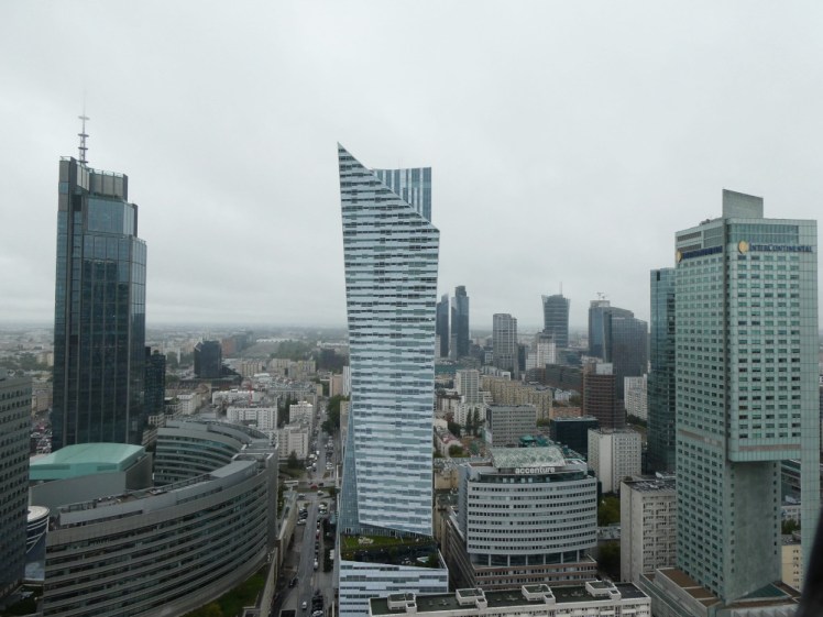 A view from the 30th floor over various fairly modern skyscrapers in an assortment of interesting shapes.