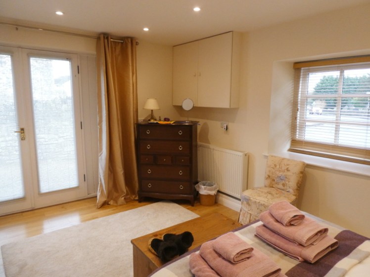 The other end of the bedroom - the drawers and the chair and my two windows