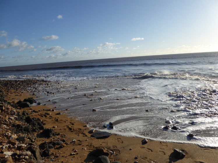 Waves coming right up the beach at Charmouth