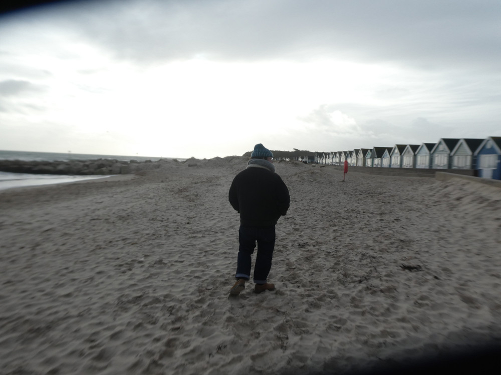 Tom walking up the beach, me following with a defective camera. The lens isn't properly open so there are black triangles in two corners and the camera has decided to make the picture almost sepia-toned.
