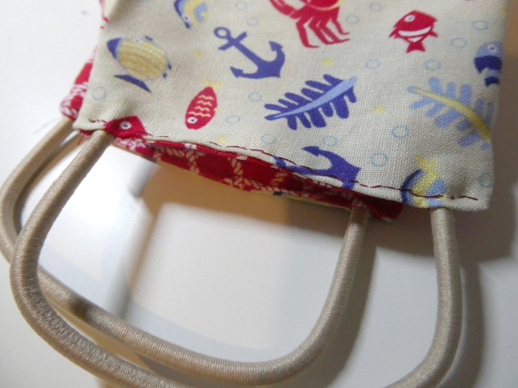 Sides of the mask sewn up with elastic in