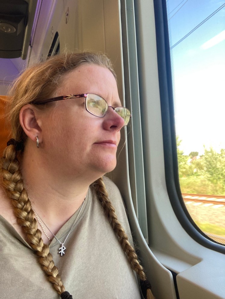 A selfie looking out of the train window, pretending I don't know I'm holding up my own camera.