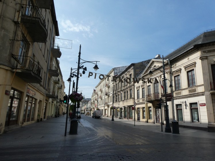 A junction of Piotrkowska, Łódź's main street, with its name strung up in big letters between lamp posts.