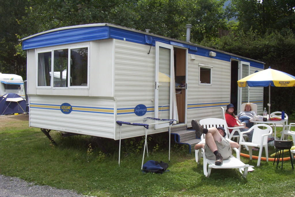 August 2004, outside our Keycamp caravan. My dad is lying on the sunlounger, my mum and sister are sitting in the reclining chairs having just finished the daily cake.