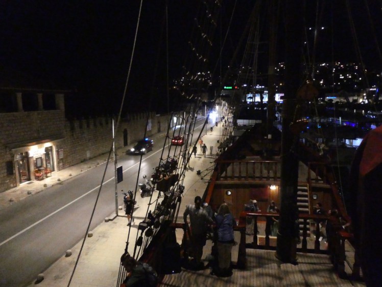 Karaka moored alongside the port, looking down at the road from the heights of the poop deck.