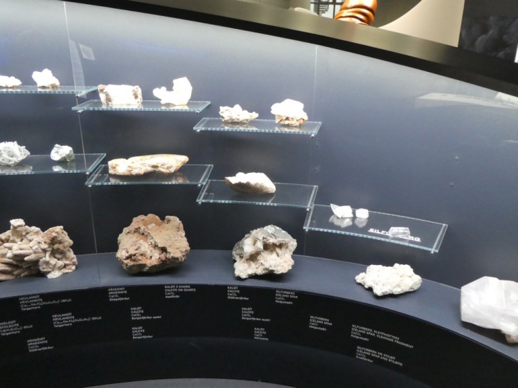 Shelves of what look like rocks in the water exhibit. They've got something to do with glaciers.