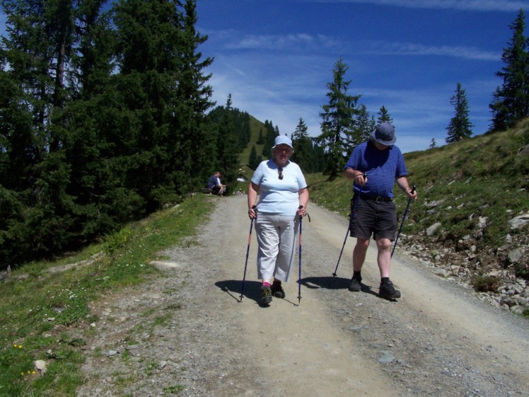 My parents walking along a gravel path in the Austrian Alps back in about 2008, both with walking poles.