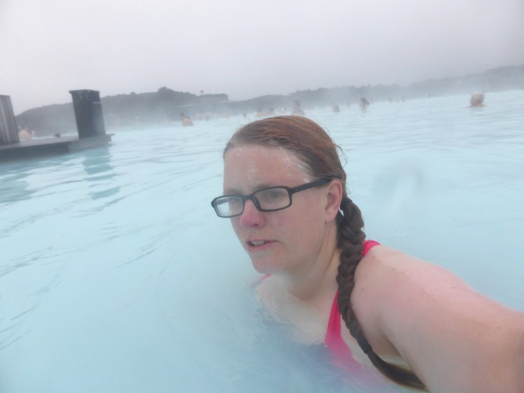 My camera case starting to steam up in the Blue Lagoon. It's a casual selfie of me not looking at the camera, on an overcast day but even so, it's misty