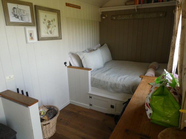 The bed at the other end of the hut