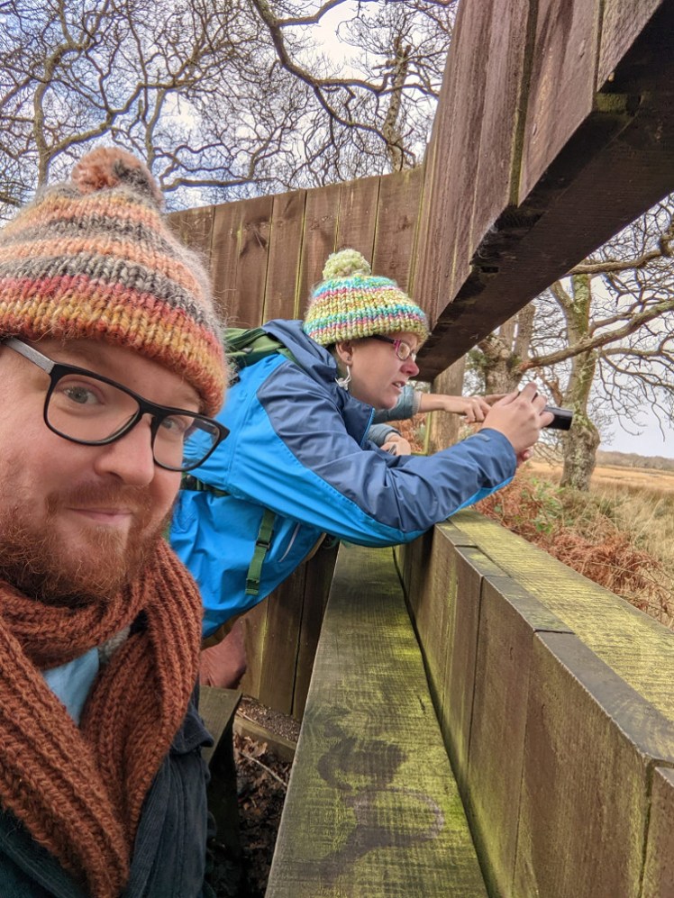 Tom takes a selfie in the hide while I, oblivious to it, photograph the spoonbills.