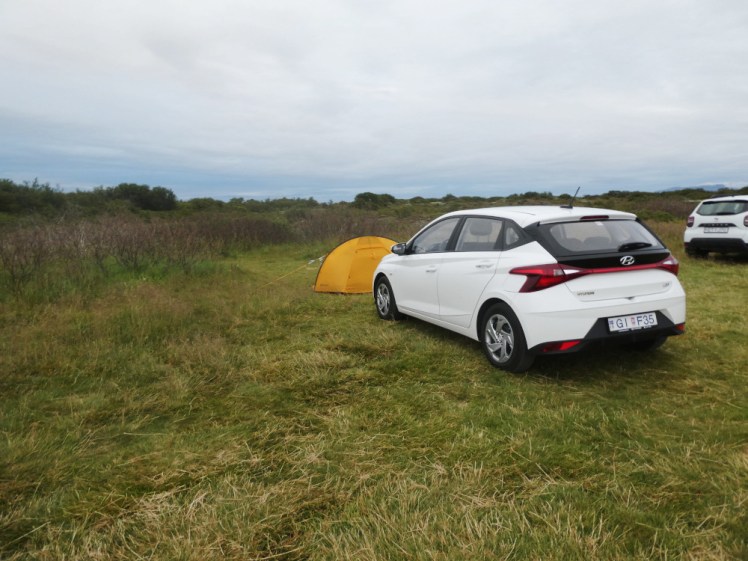 My little yellow tent poking out from behind my white Hyundai i20 in a field at Þingvellir.