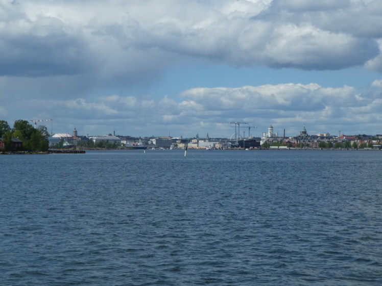 Helsinki from the water, the city visible in the distance across a lot of water.