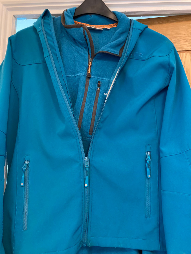 My blue fleece on a hanger hanging from a door. Over the top of it, partially zipped, is my softshell in an (accidental) almost identical shade of blue.