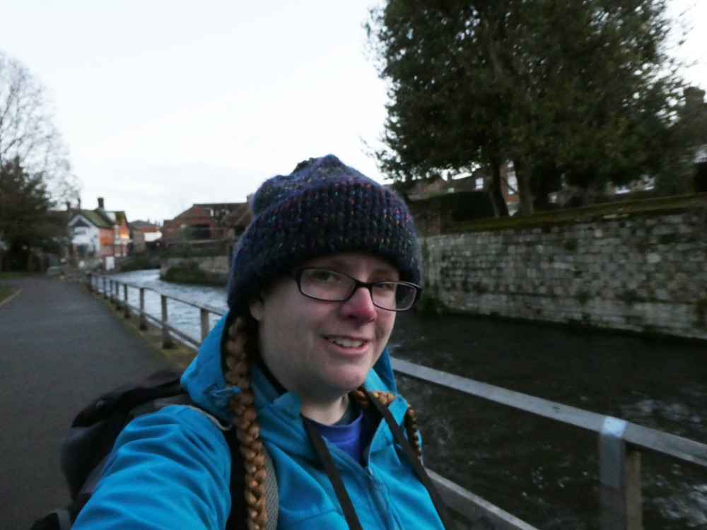A selfie by the river in Winchester. I hadn't realised how dark it was - it's still visibly pretty dark after I've lightened the photo. I'm wearing a navy bobble hat and a bright blue softshell and my face is a bit pink from the chill in the air.