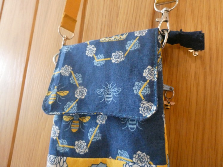 The front of the bag. There's a flap in the navy fabric folded down over the navy part of the front and you can just see the yellow lower front.