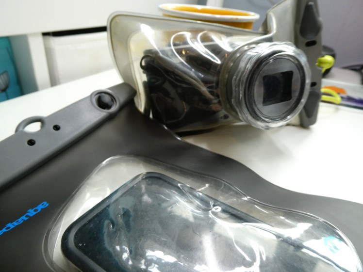 Phone & camera in Aquapac waterproof cases. The camera case has a special tube on the front for the camera's zoom.
