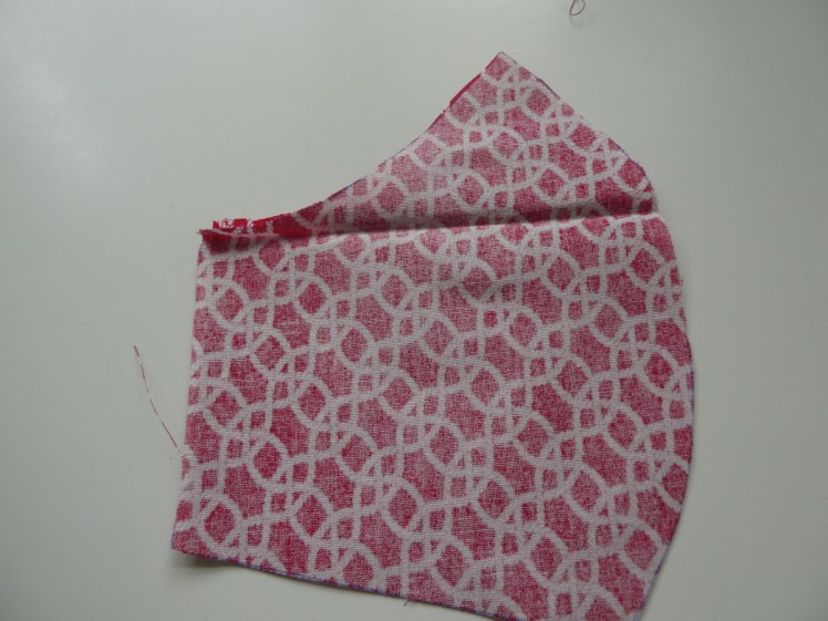 The two pieces of mask fabric put together, face to face ready to sew