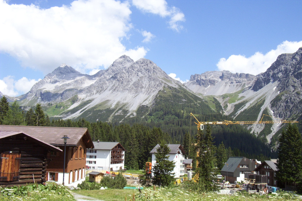 Some of the more traditional-style chalets among the woods in Arosa. However, a big yellow crane says there's probably a modern building there by now.