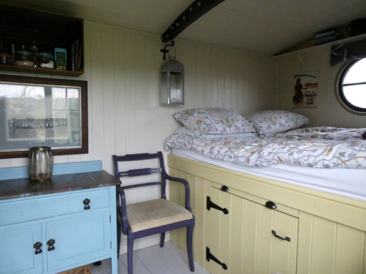 The high bed in the shepherd's hut and the cupboard underneath