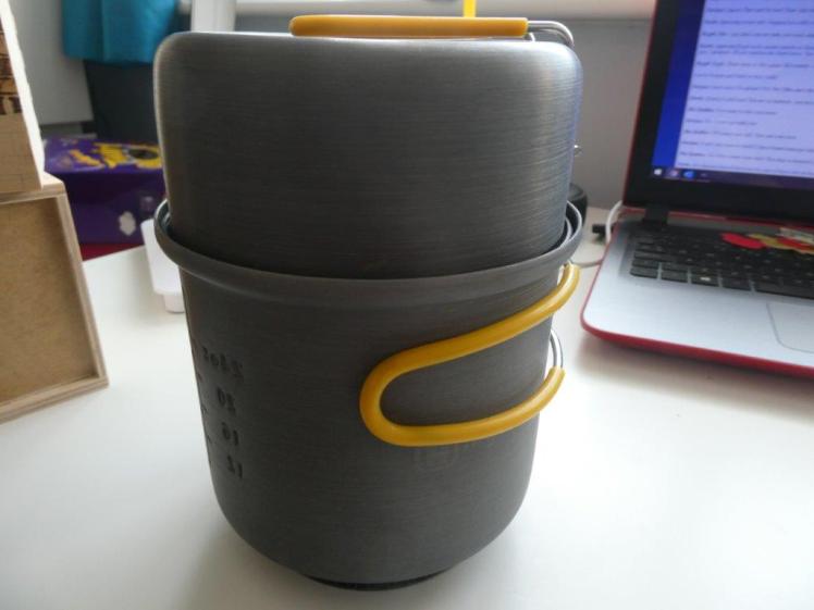 HiGear one person cookset - a pot shaped a bit like a mug with rubber folding handles, and a deep saucepan on top acting as a lid