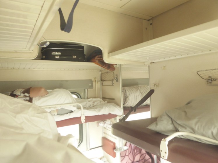 Inside a third class sleeping carriage on the Trans Siberian Railway. It's early in the morning and the beds are still made up.