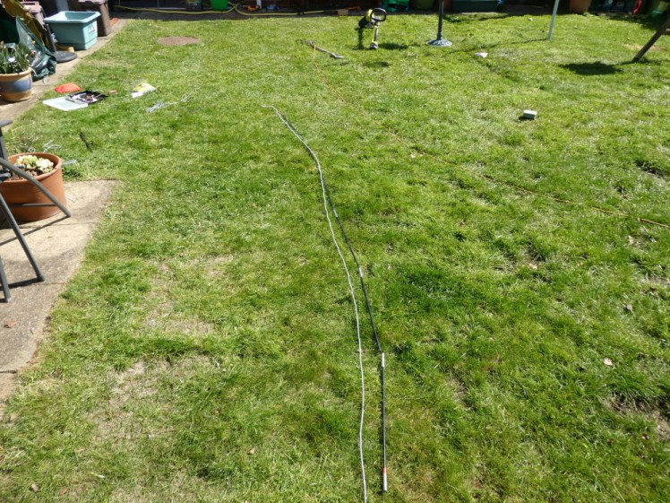 Pole laid out with elastic being measured alongside