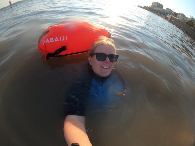 Selfie from above in visibly muddy water. It's a bit lighter than Friday and my tow float is glowing with the sun behind it.