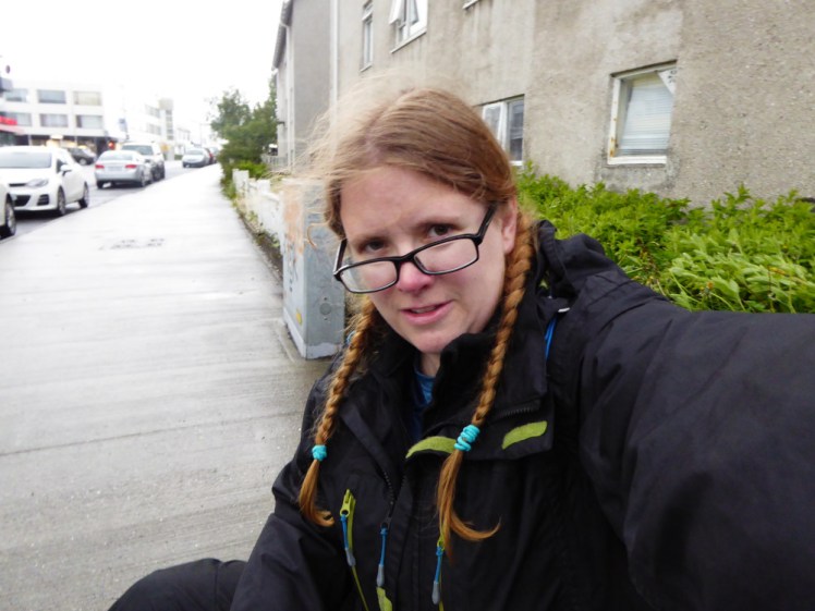 Sitting outside on a residential street, on my bag, waiting for a taxi at about 7am in Iceland.