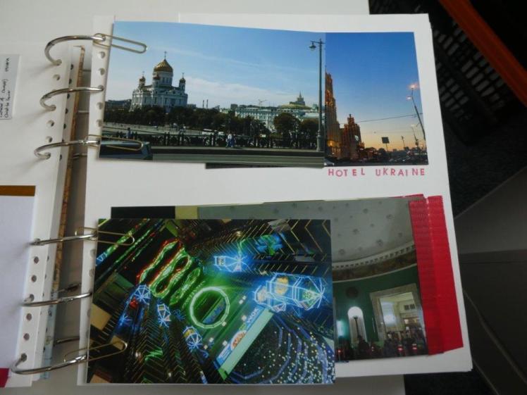 A half-page. Four photos, stuck back to back to make two double-sided photos, are attached to the scrapbook's binder rings with gold paperclips to make two small extra pages.