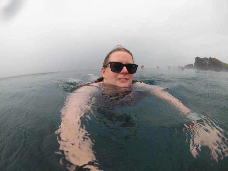 Me swimming in the rough water on the cloudy day. Behind me is the infinity edge and it's too cloudy to really appreciate it.