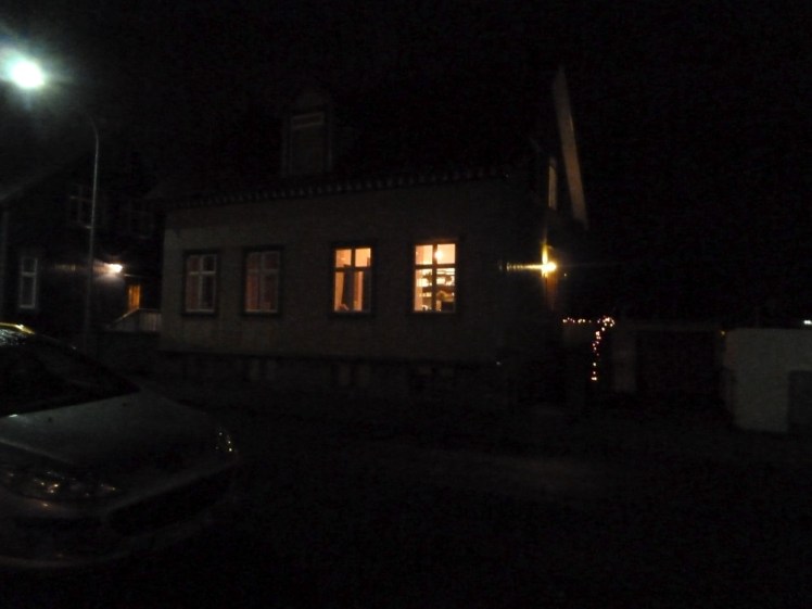 Waiting outside my guesthouse to be picked up from the tour. It's very dark, give or take the streetlight and the lights on inside the house.